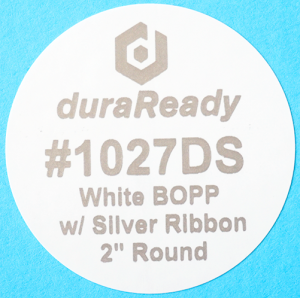 DuraReady's #1027DS, 2" round white BOPP label with silver print.